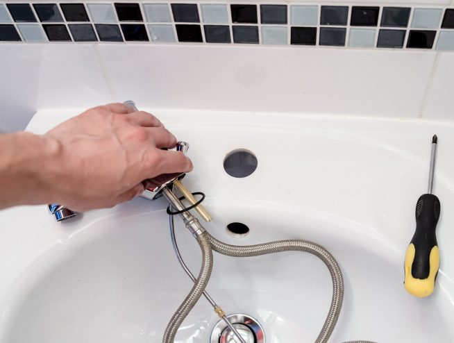Plumber repairing water fixture